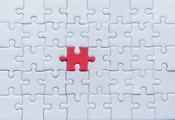 Jigsaw with one piece missing revealing