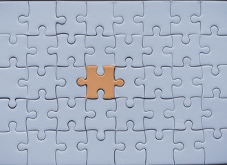 Jigsaw with one piece missing revealing
