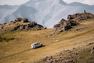 Car rides on top of the mountain. Alpine scenery at Altai Mountains