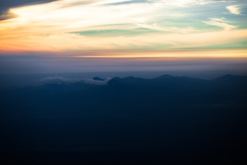 Obraz premium Background, high angle from the passenger plane. You can see the scenery by the distance (mountains, rivers, sky, fog, houses), the photos may be blurred during the flight.