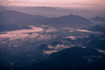 Background, high angle from the passenger plane. You can see the scenery by the distance (mountains, rivers, sky, fog, houses), the photos may be blurred during the flight.