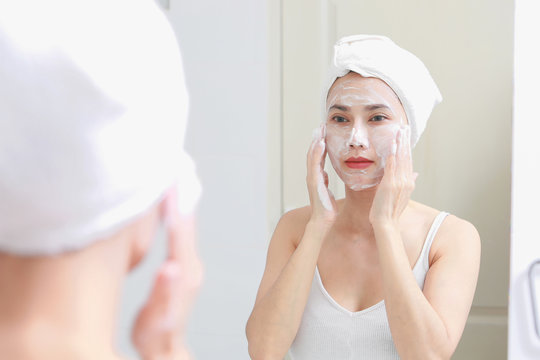 Asian woman cleaning face skin enjoy herself with bubble cleansing foam.