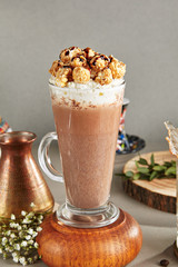 Cocoa Drink with Whipped Cream and Caramel Popcorn in Tall Glass Served in Restaurant