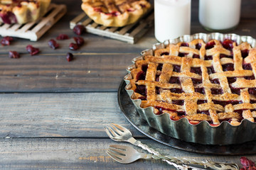 Traditional American cherry pie on a dark wooden background