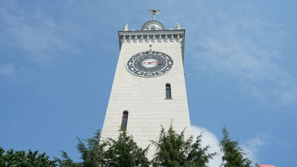The clock tower of the Sochi railway station with a zodiac signs