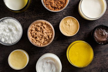 A set of different scrubs and body creams, top view.