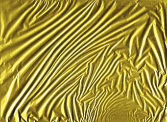 Shiny yellow gold crumpled wrapping paper foil texture for wallpaper decoration element background, stock photo image