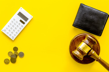 Financial failure, bankruptcy concept. Judge gavel, wallet, coins, calculator on yellow background top view copy space