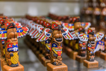 Carved wooden miniature First Nations or Native American Indian totem pole souvenirs at a tourist...