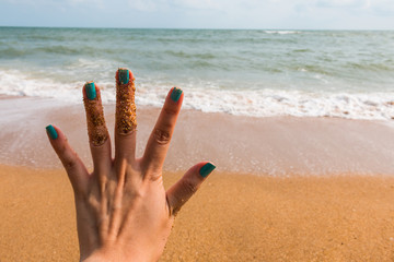 Fototapeta na wymiar Five fingers with sea background