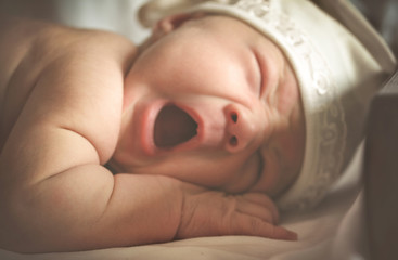 portrait of a newborn yawning baby