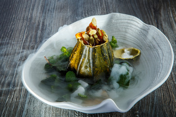 delicious dessert served in pumpkin decorated with mint and smoke