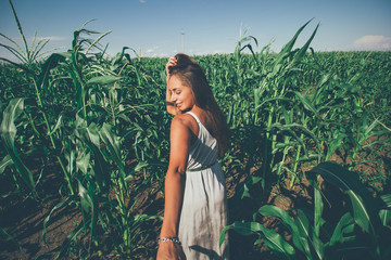 beautiful young woman tanned skin silver dress in the corn field portrait of follow me