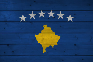 Flag of Kosovo on wooden background, surface. Wooden wall, planks. National flag.