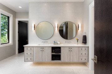 Elegant bathroom in new luxury home with two sinks and two mirrors