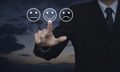Businessman pressing excellent smiley face rating icon over sunset sky, Business customer service...