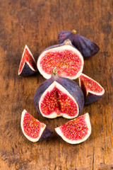 Group of sliced ripe, delicious and sweets figs on a old rustic wooden cutting board