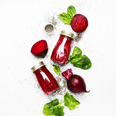 Delicious beetroot smoothies in glass bottles with chia on white food background, top view - obrazy, fototapety, plakaty