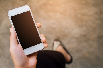 Close up of  woman hands holding touching mobile phone with blank copy space for your text message in cafe with light Sunset,Vintage tone.Selective focus