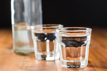 Vodka in shot glass. - obrazy, fototapety, plakaty