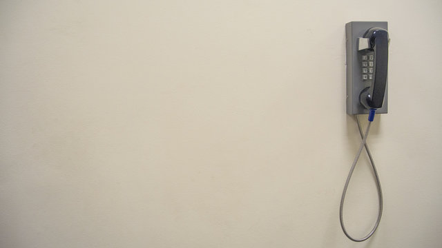 Vintage old phone mounted on a white wall