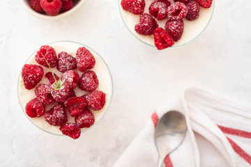 Raspberry dessert, raspberry tiramisu, cheesecake, trifle, mousse in a glass on a wooden background.Top view