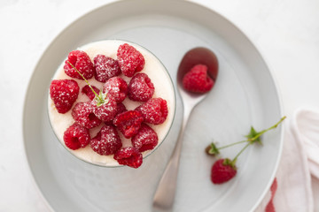 Raspberry dessert, raspberry tiramisu, cheesecake, trifle, mousse in a glass on a wooden background.Top view