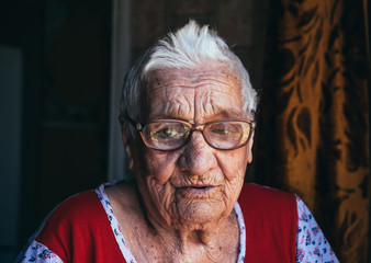 Portrait of a laughing hundred-year-old retired woman