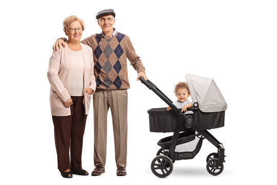 Happy grandparents standing with a pushchair and their grandson