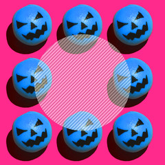 spooky blue pumpkins on pink background with space for text in the middle round circle. Halloween style