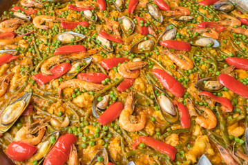 Seafood paella on a large frying pan, close up