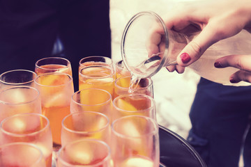 pour white wine into glasses, round of drinks