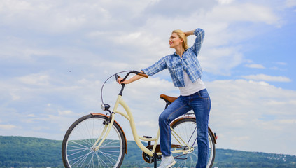 Health benefits of cycling. Reasons to ride bike. Woman rides bicycle sky background. Increase muscle strength and flexibility by riding bike. Benefits of cycling every day. Girl ride cruiser bicycle