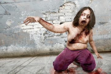 Spooky zombie man with wound on his body