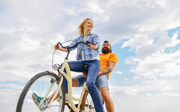 Couple in love date cycling. Couple with bicycle romantic date sky background. Let her be leader. Psychology of relationships. Leadership in family and marriage. Girl controls bicycle handlebar © be free