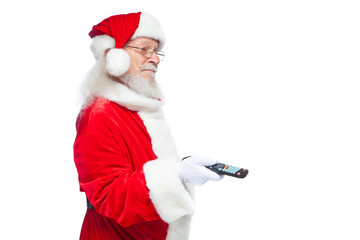 Christmas. Santa Claus in white gloves holding a TV remote control. Browse Christmas TV listings, select the channel. Isolated on white background.
