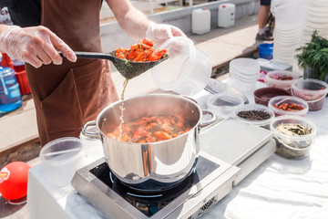 The cook prepares crawfish in boiling water in a pan