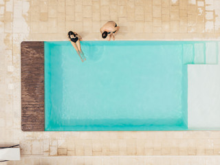 top view of couple resting at poolside in Italy