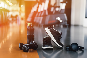 Exercise workout equipment at gym fitness training sport dumbbell,headphone,shoes,protein shake healthy lifestyle relax bodybuilding on top view.