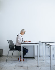 Teacher Sitting at Classroom