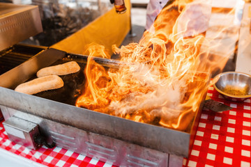 chef prepare food with flames of open fire