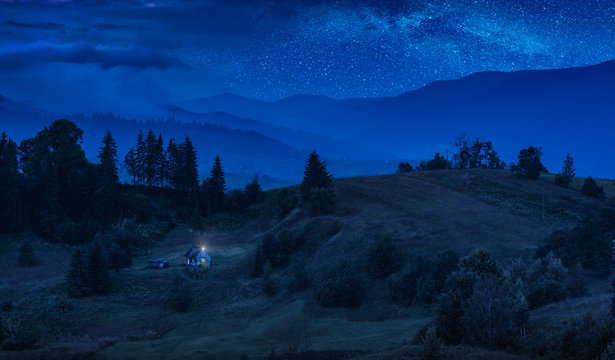 Fototapeta House on a mountain hill under the starry sky