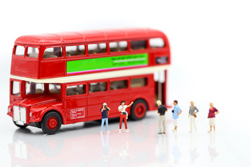 Miniature people : traveling with friend and bus using for concept of Tourism day.