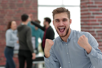 Handsome  businessman celebrating victory shouting happily in th