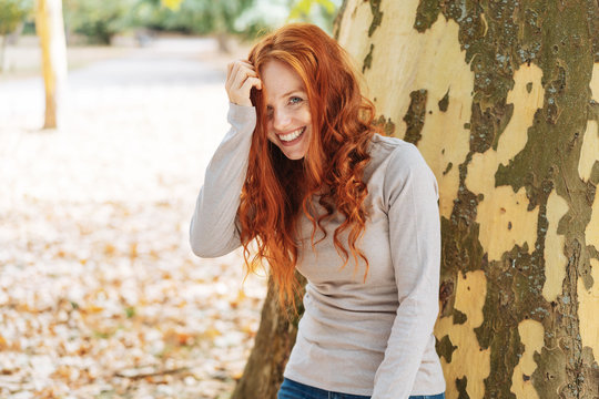 Laughing cute young redhead woman