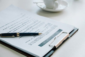 Insurance application and pen to Signing of Business Agreement.