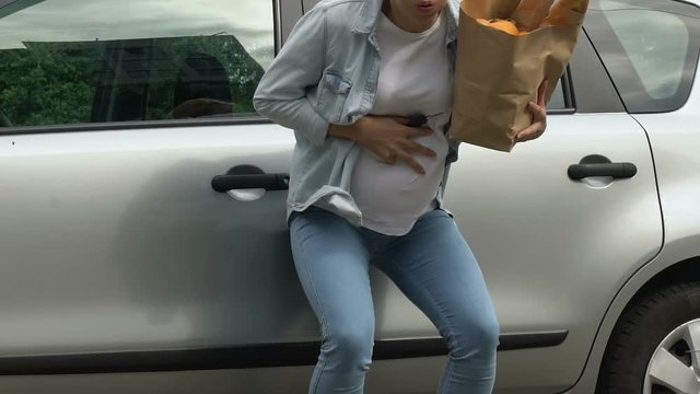 Pregnant woman drops bag with food, feels labor contractions pain, miscarriage