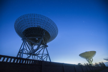 The silhouette of a radio telescope