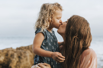 Mom with young daughter at a beach