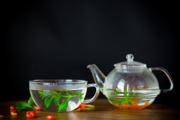 hot tea from ripe red goji berries in a glass teapot